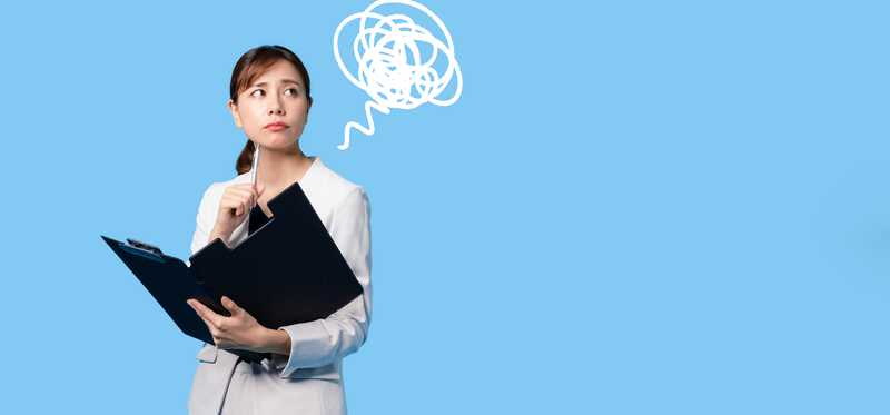 Confused businesswoman holding a document file