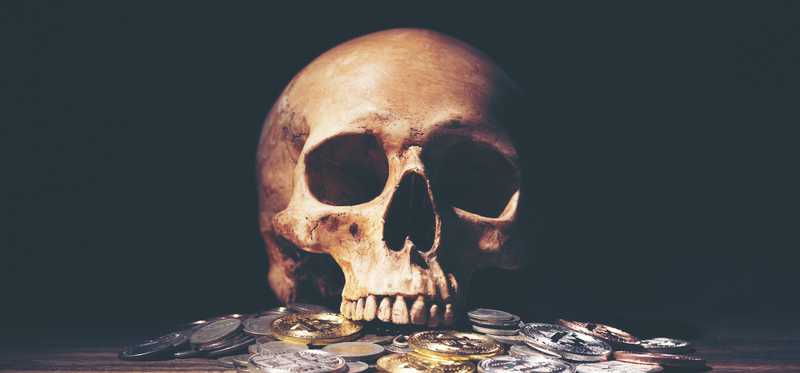 Skull with scattered coins