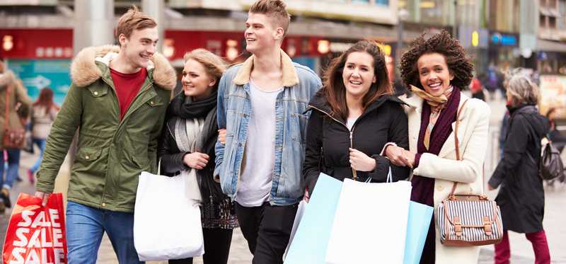 Group of young people shopping outside in winter