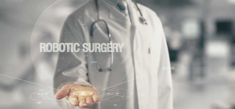 A doctor with hand outstretched below the words Robotic Surgery.
