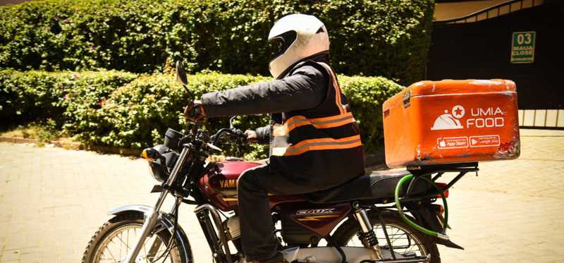 A Jumia delivery person on a motorbike.