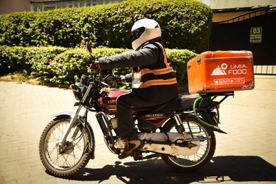 A Jumia delivery person on a motorbike.
