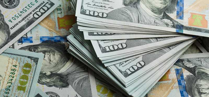 large pile of hundred dollar bills
