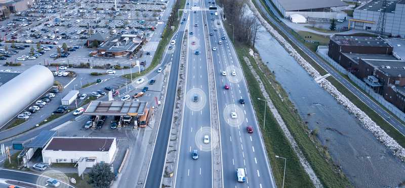 Technology pointing out cars driving down a highway.