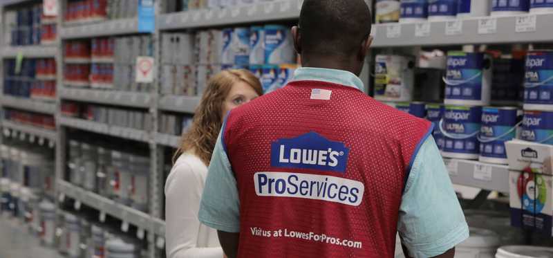 Lowe's employee helping a customer.