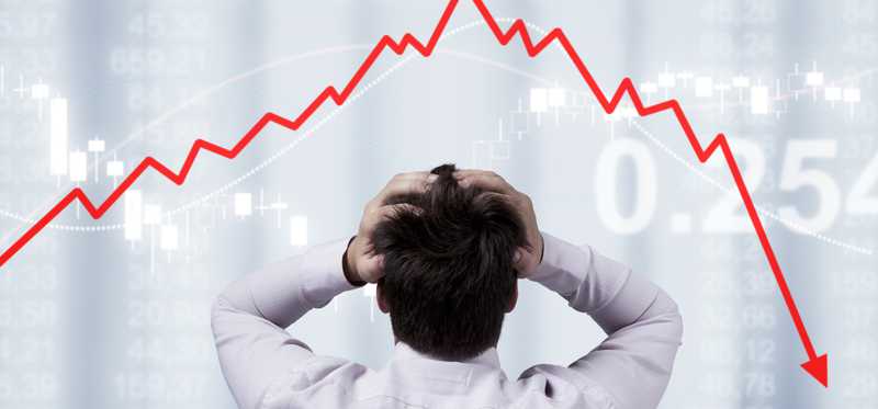 Person stressed watching stock market crash.