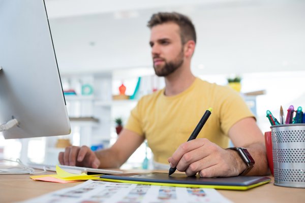 Person at computer taking notes.