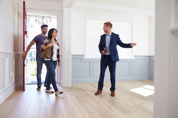Real estate agent showing a home to two people.