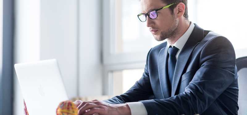 Man in suit at laptop