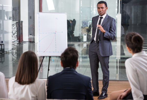 Man in a suit giving a presentation.
