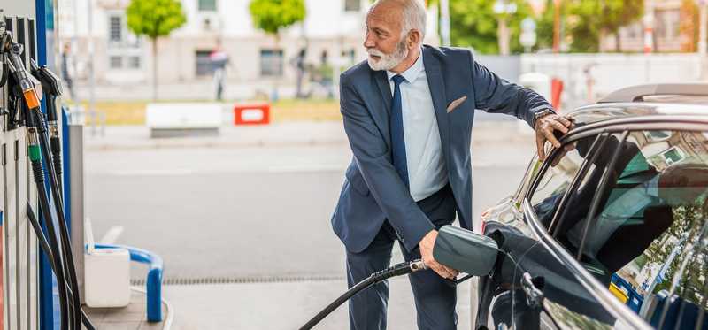 A person pumping gas into a car.