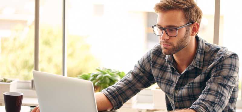 Person typing on a laptop at a desk.