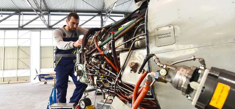 Man working on an aircraft engine.
