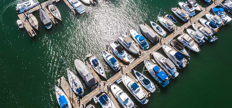 An overhead shot of many boats docked at a marina.