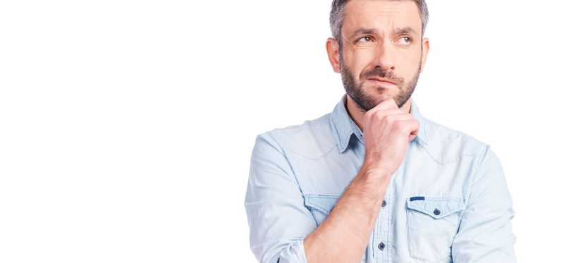 Mature man with hand to his chin in thought.