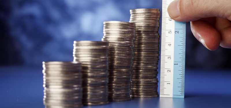 A ruler measuring stacks of quarters.
