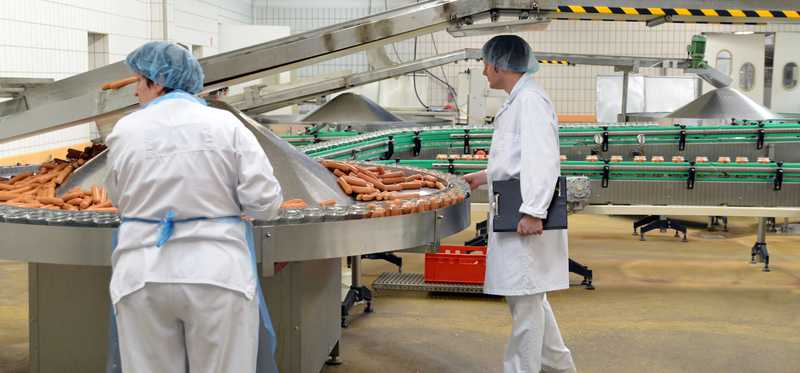 People working in a meat processing plant.