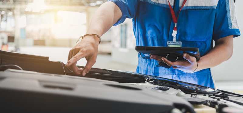 Mechanic working on car engine