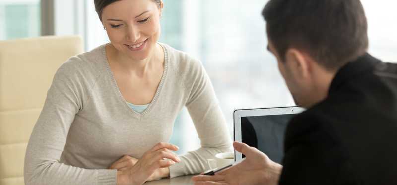 Two people meet in an office.