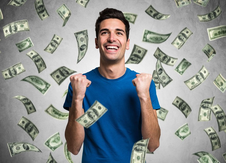 Money raining on person smiling and celebrating.