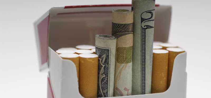Money rolled up in a cigarette box.