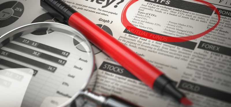 Newspaper article about investing in ETFs circled with red marker