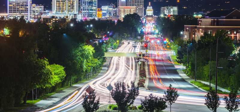 A night view of Boise, Idaho, traffic and its capitol building and skyline.