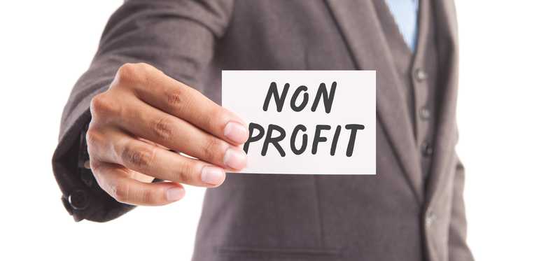A man holds up a sign that says nonprofit