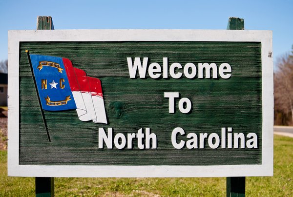 A highway road sign that reads Welcome to North Carolina.