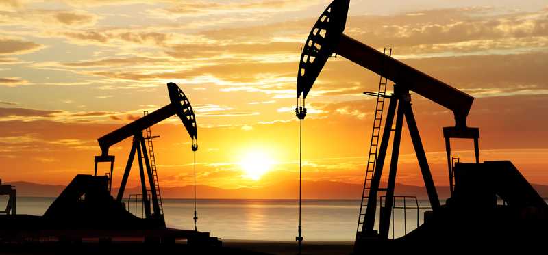 Two oil pumps in the sunset.