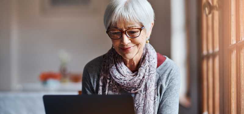 Person using a laptop in home setting.