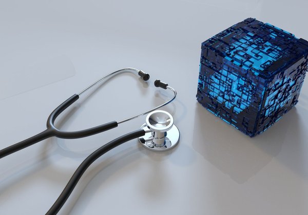 Stethoscope next to a blue block.