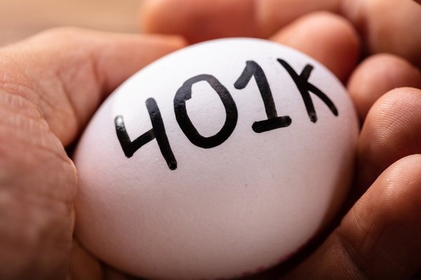 white egg with "401K" resting in a person's right hand