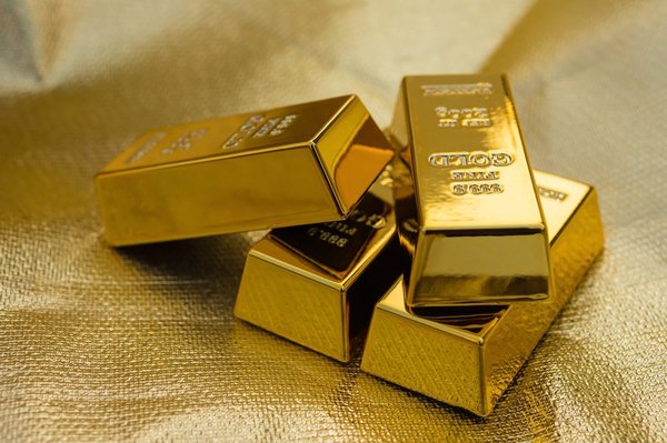 Four gold bars on a gold-colored background.