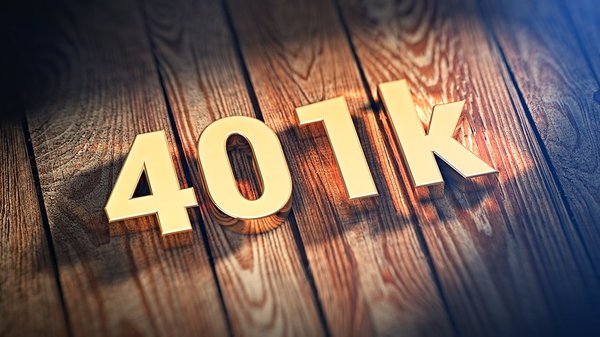 401K written with golden blocks sit on a wooden table.