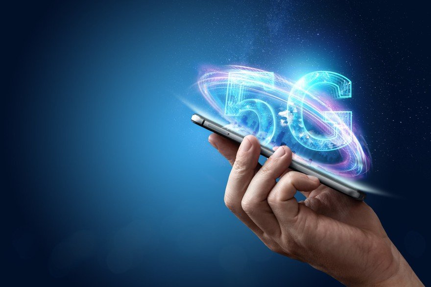 Someone holding a smartphone. "5G" is illustrated over the screen.