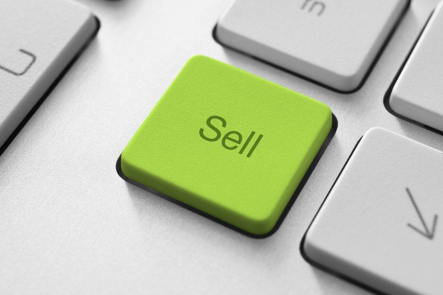 Green button labeled Sell on a keyboard