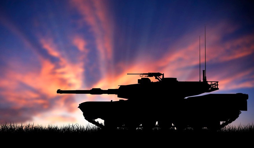 A tank silhouetted against a sunset.