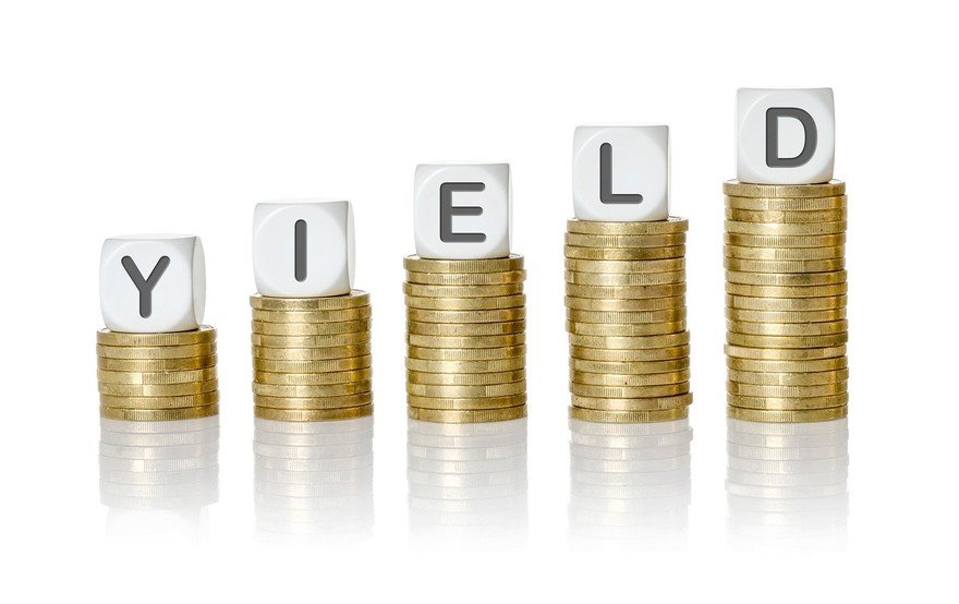 Stacks of coins progressively higher with the letters from the word yield on top of the stacks.