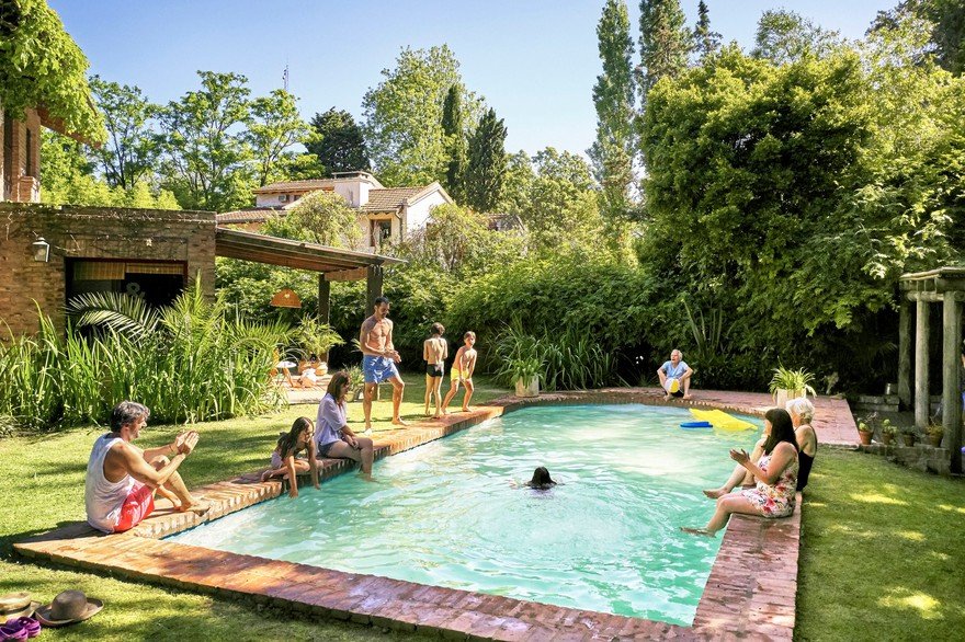 Family around pool at home.