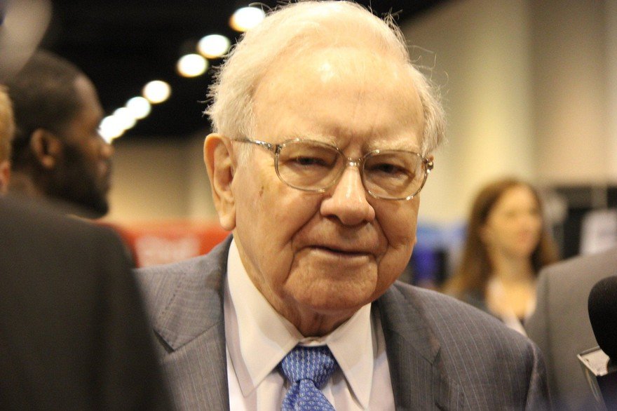 Warren Buffett with people in the background