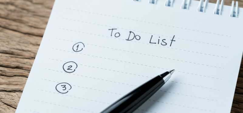 Pen resting on top of a to-do list.