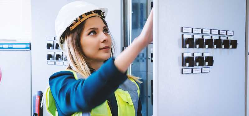 Person at a panel in a power plant.