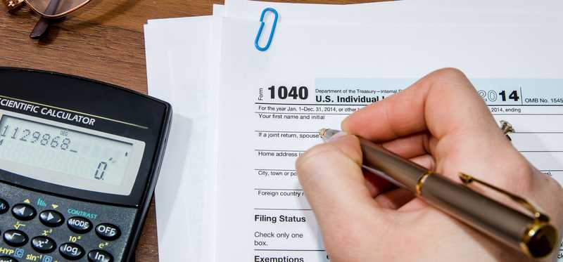 person filling out IRS form 1040