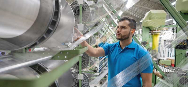 A person working in a tape factory.