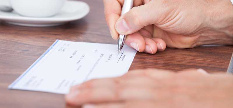 Person writing a check.