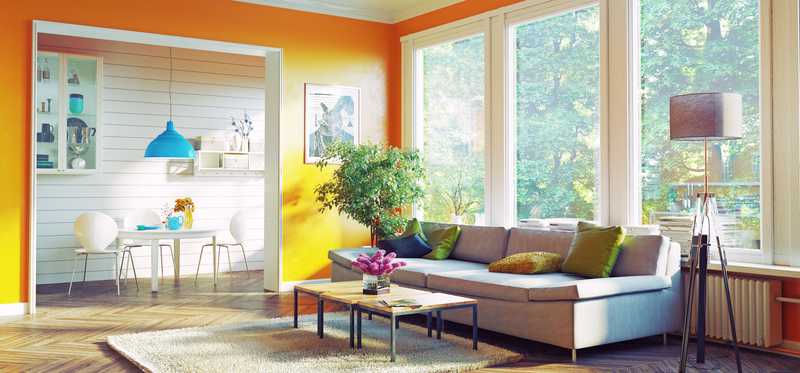 A well-decorated living room with modern décor and bright paint.