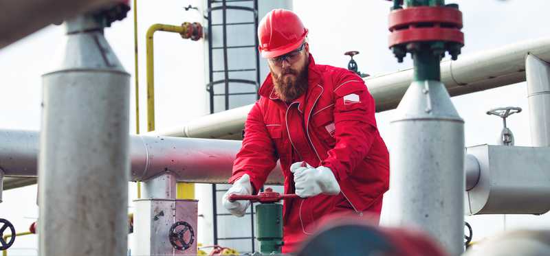 Person working on oil and gas pipelines.