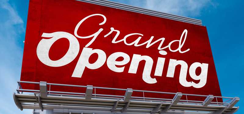 A large grand opening sign.