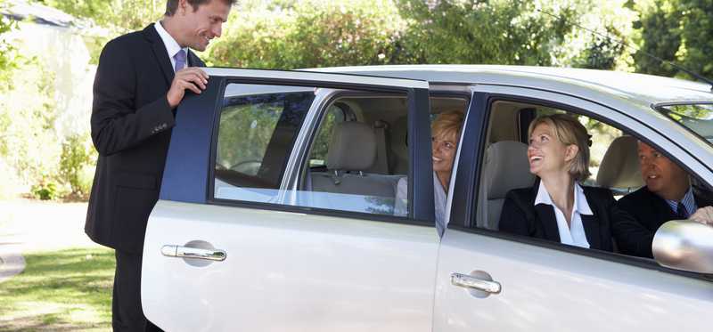 A person gets into a crowded car.